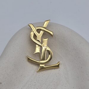 YSL - złota broszka vintage z monogramem