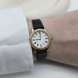 YSL - klasyczny złoty zegarek vintage na czarnym pasku na ręce