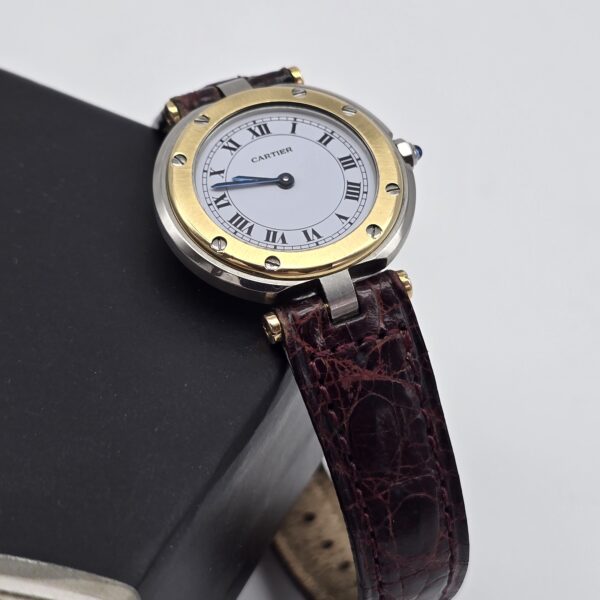 CARTIER - elegancki zegarek vintage, Santos Ronde, lata 90. na książce